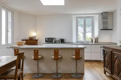 a kitchen with a large island with bar stools at Cinema - Lumineux Moderne 2CH 100m2 Hypercentre Vues in Chamonix-Mont-Blanc