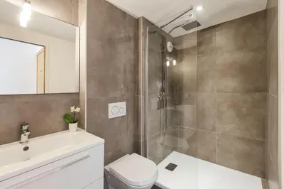 a bathroom with a shower and a toilet and a sink at Cordee - Appart 2CH Balcon SUD Vues Residence Premium in Chamonix-Mont-Blanc