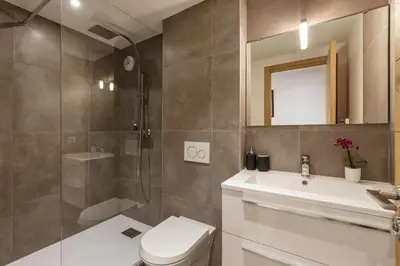 a bathroom with a toilet and a sink and a shower at Cordee - Appart 2CH Balcon SUD Vues Residence Premium in Chamonix-Mont-Blanc