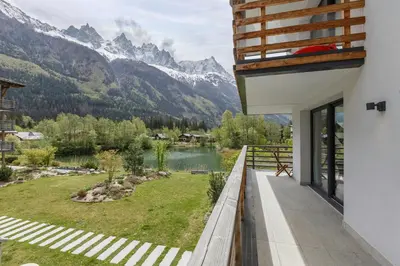 a balcony with a view of a lake and mountains at Cordee - Appart 2CH Balcon SUD Vues Residence Premium in Chamonix-Mont-Blanc