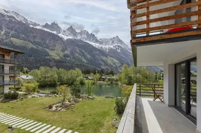 a balcony with a view of a lake and mountains at Cordee - Appart 2CH Balcon SUD Vues Residence Premium in Chamonix-Mont-Blanc