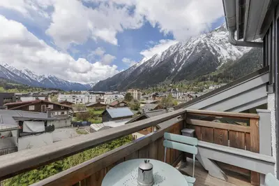 a balcony with a view of the mountains at Flocon - Loft Moderne 8pax Sauna Poele Vues Garage in Chamonix-Mont-Blanc