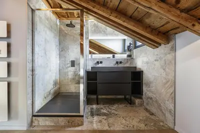 a bathroom with a sink and a mirror at Flocon - Loft Moderne 8pax Sauna Poele Vues Garage in Chamonix-Mont-Blanc