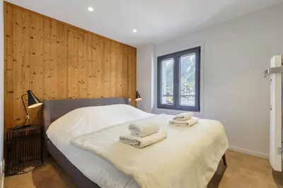 a bedroom with a bed with towels on it at Flocon - Loft Moderne 8pax Sauna Poele Vues Garage in Chamonix-Mont-Blanc