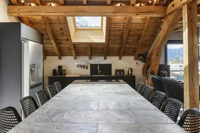 a conference room with a large table and chairs at Flocon - Loft Moderne 8pax Sauna Poele Vues Garage in Chamonix-Mont-Blanc