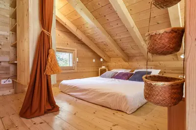 a bedroom with a bed in a wooden cabin at Gaillands Mazot Lumineux 55m2 Vues Confort in Chamonix-Mont-Blanc