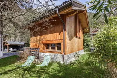 a house with two chairs in front of it at Gaillands Mazot Lumineux 55m2 Vues Confort in Chamonix-Mont-Blanc