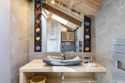 a bathroom with a sink and a mirror at Gaillands Mazot Lumineux 55m2 Vues Confort in Chamonix-Mont-Blanc
