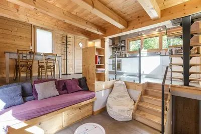 a living room with a couch in a tiny house at Gaillands Mazot Lumineux 55m2 Vues Confort in Chamonix-Mont-Blanc