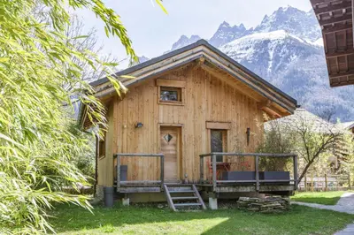 a wooden cabin with mountains in the background at Gaillands Mazot Lumineux 55m2 Vues Confort in Chamonix-Mont-Blanc