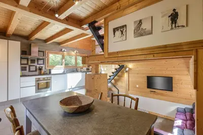 a kitchen and dining room with a table in a cabin at Gaillands Mazot Lumineux 55m2 Vues Confort in Chamonix-Mont-Blanc