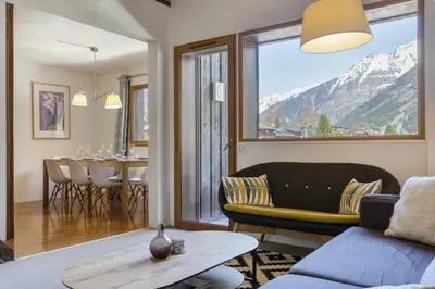 a living room with a couch and a table at Refuge Scandinave - Duplex 80m2 Vue Garage Calme 200m TrainBus in Chamonix-Mont-Blanc
