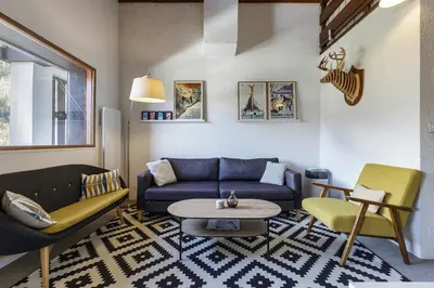 a living room with a couch and a table at Refuge Scandinave - Duplex 80m2 Vue Garage Calme 200m TrainBus in Chamonix-Mont-Blanc