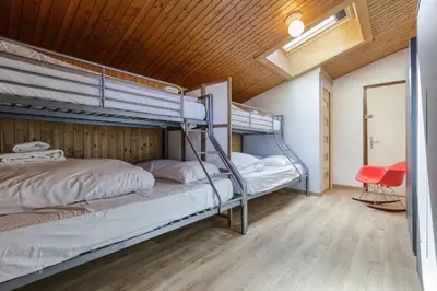 two bunk beds in a room with a wooden ceiling at Refuge Scandinave - Duplex 80m2 Vue Garage Calme 200m TrainBus in Chamonix-Mont-Blanc