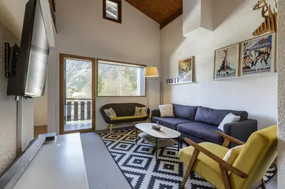 a living room with a couch and a table at Refuge Scandinave - Duplex 80m2 Vue Garage Calme 200m TrainBus in Chamonix-Mont-Blanc