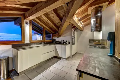a kitchen with wooden ceilings and a large window at Chosalets - Chalet 200m2 Cheminee Jacuzzi Sauna Vues in Chamonix-Mont-Blanc