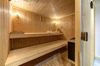 a sauna with a bench in a wooden room at Chosalets - Chalet 200m2 Cheminee Jacuzzi Sauna Vues in Chamonix-Mont-Blanc
