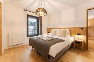 a bedroom with a large bed and a window at Chatelet Appart 3CH Proche remontees Centrale Vues in Saint-Gervais-les-Bains