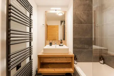 a bathroom with a sink and a mirror and a shower at Chatelet Appart 3CH Proche remontees Centrale Vues in Saint-Gervais-les-Bains