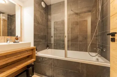 a bathroom with a tub and a sink at Chatelet Appart 3CH Proche remontees Centrale Vues in Saint-Gervais-les-Bains