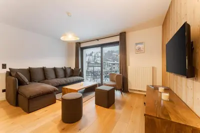 a living room with a couch and a tv at Chatelet Appart 3CH Proche remontees Centrale Vues in Saint-Gervais-les-Bains