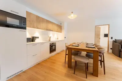 a kitchen and dining room with a table and chairs at Chatelet Appart 3CH Proche remontees Centrale Vues in Saint-Gervais-les-Bains
