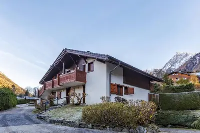 a house in the mountains with a road at Griaz - Cocon 1CH Terrasse Confort Bureau Parking in Les Houches