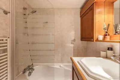 a bathroom with a shower and a tub and a sink at Griaz - Cocon 1CH Terrasse Confort Bureau Parking in Les Houches