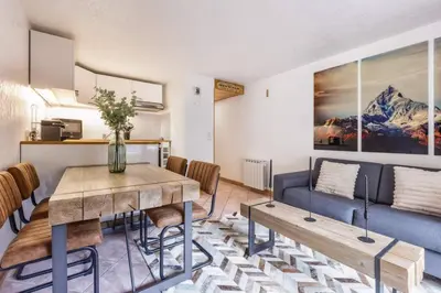 a living room with a table and a couch at Griaz - Cocon 1CH Terrasse Confort Bureau Parking in Les Houches
