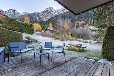a deck with chairs and a table and a picnic table at Griaz - Cocon 1CH Terrasse Confort Bureau Parking in Les Houches