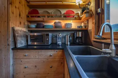 a kitchen with a sink and a microwave at Ibex - Chalet 170m2 Cheminee Vue Confort Calme in Les Houches
