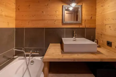 a bathroom with a white sink and a tub at Ibex - Chalet 170m2 Cheminee Vue Confort Calme in Les Houches