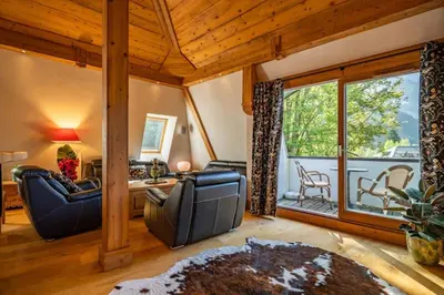a living room with furniture and a large window at Astoria - UltraCentral 140m2 Balcons Vues Balneo Sauna in Chamonix-Mont-Blanc