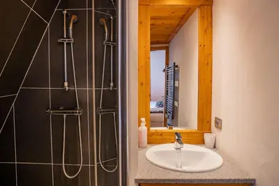 a bathroom with a sink and a shower at Astoria - UltraCentral 140m2 Balcons Vues Balneo Sauna in Chamonix-Mont-Blanc
