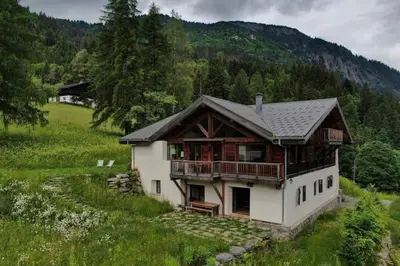 a large house with a balcony on a hill at Gublin - Apart Famille Vue360 Nature Calme Cheminee in Les Houches