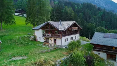 a house on top of a hill with trees at Gublin - Apart Famille Vue360 Nature Calme Cheminee in Les Houches