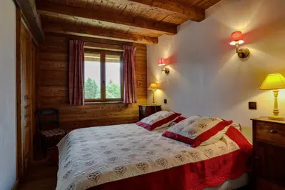 a bedroom with a bed in a room with a window at Prarion - Chalet Familial Vue360 Nature Calme Unique in Les Houches