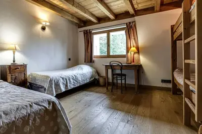 a bedroom with two beds and a desk and a window at Prarion - Chalet Familial Vue360 Nature Calme Unique in Les Houches