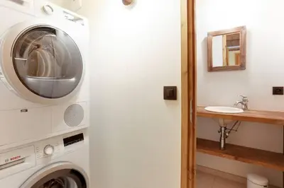 a washing machine in a bathroom with a sink at Prarion - Chalet Familial Vue360 Nature Calme Unique in Les Houches