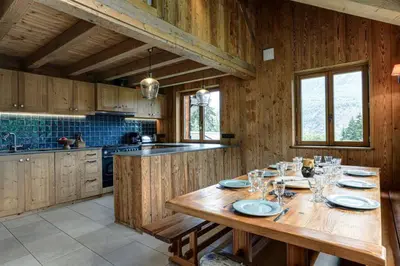 a kitchen with a wooden table with glasses on it at Prarion - Chalet Familial Vue360 Nature Calme Unique in Les Houches