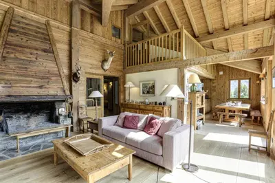 a living room with a couch and a fireplace at Prarion - Chalet Familial Vue360 Nature Calme Unique in Les Houches