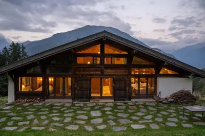 a house with large windows and a mountain at Prarion - Chalet Familial Vue360 Nature Calme Unique in Les Houches
