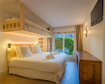a bedroom with a bed with a loft bed at Mummery - Central T2 Pied piste Vue Parking Terrasse in Chamonix-Mont-Blanc