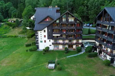 an aerial view of a large building on a green field at Mummery - Central T2 Pied piste Vue Parking Terrasse in Chamonix-Mont-Blanc