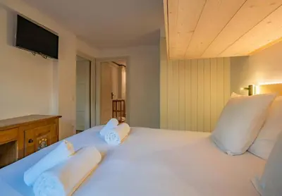 a bedroom with a large white bed with two pillows at Mummery - Central T2 Pied piste Vue Parking Terrasse in Chamonix-Mont-Blanc