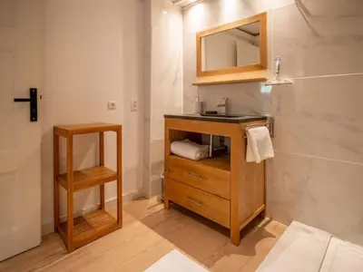 a bathroom with a sink and a mirror at Mummery - Central T2 Pied piste Vue Parking Terrasse in Chamonix-Mont-Blanc