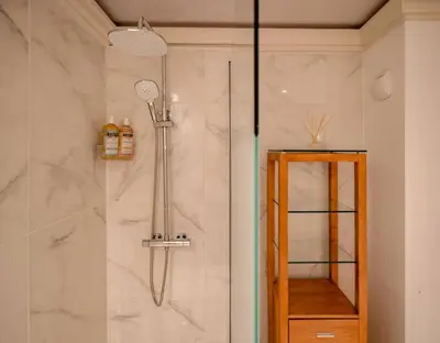 a bathroom with a shower with a glass door at Mummery - Central T2 Pied piste Vue Parking Terrasse in Chamonix-Mont-Blanc