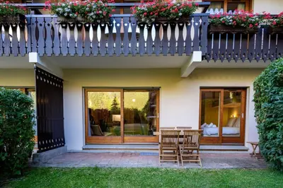 a house with two chairs and a balcony at Mummery - Central T2 Pied piste Vue Parking Terrasse in Chamonix-Mont-Blanc