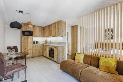 a living room with a couch and a table at Balmat - UltraCentral 2pax Confort Vue Quartier Vivant in Chamonix-Mont-Blanc