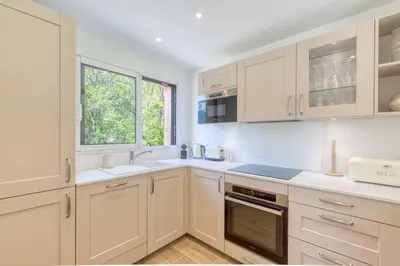 a kitchen with white cabinets and a window at Couchant Chalet Lumineux 6pax Vues Terrasses Confort in Chamonix-Mont-Blanc